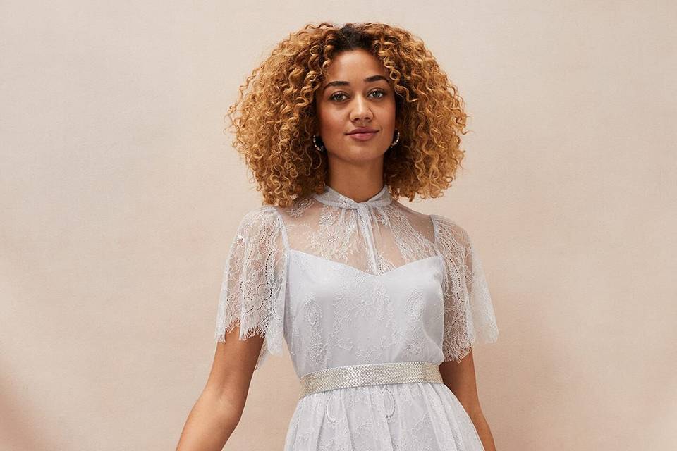 Woman wearing a pastel blue dress with tiers and lots of lace