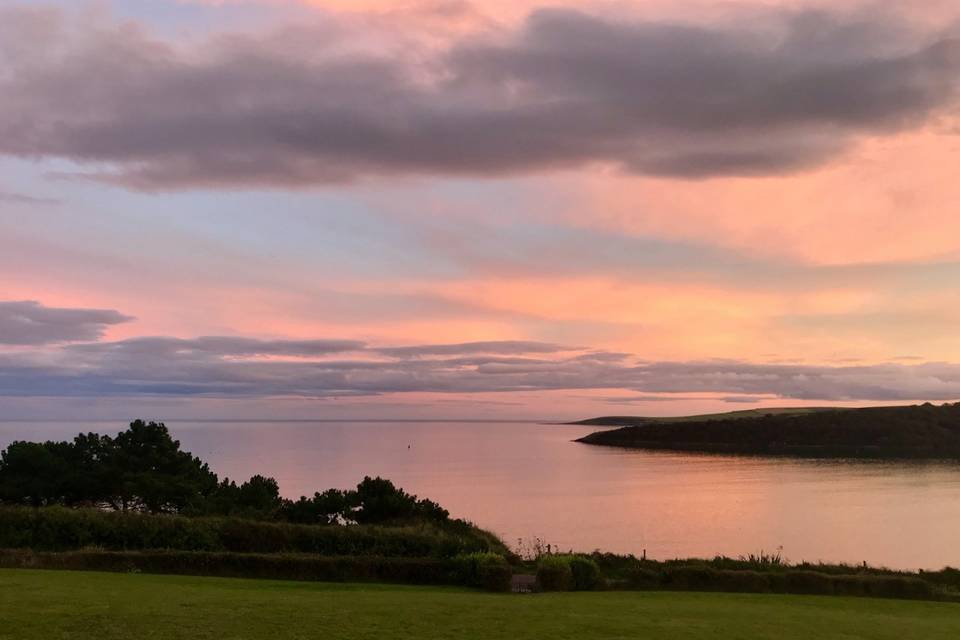 A gorgeous pink sunset over the water by the Pink Elephant wedding venue