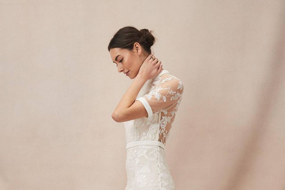 White gown with short sleeves and all over floral lace with a sheer back panel