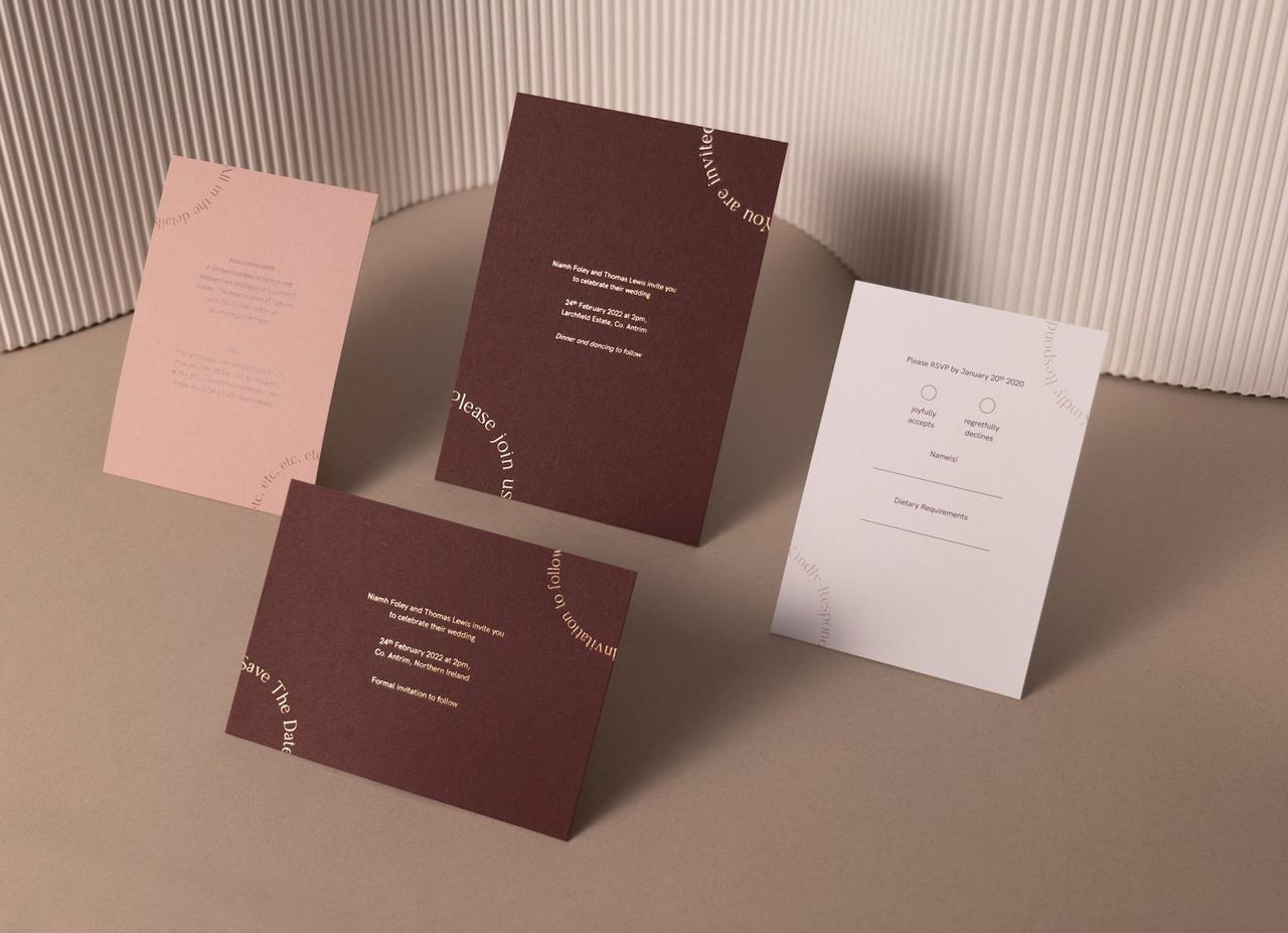 image of a minimalist stationery suite in deep reds, pinks, and white