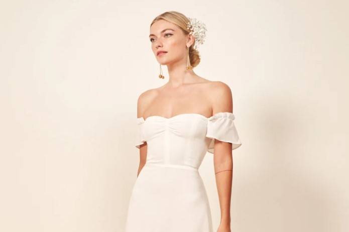 Off-the-shoulder ivory dress with flowing skirt and fitted bodice