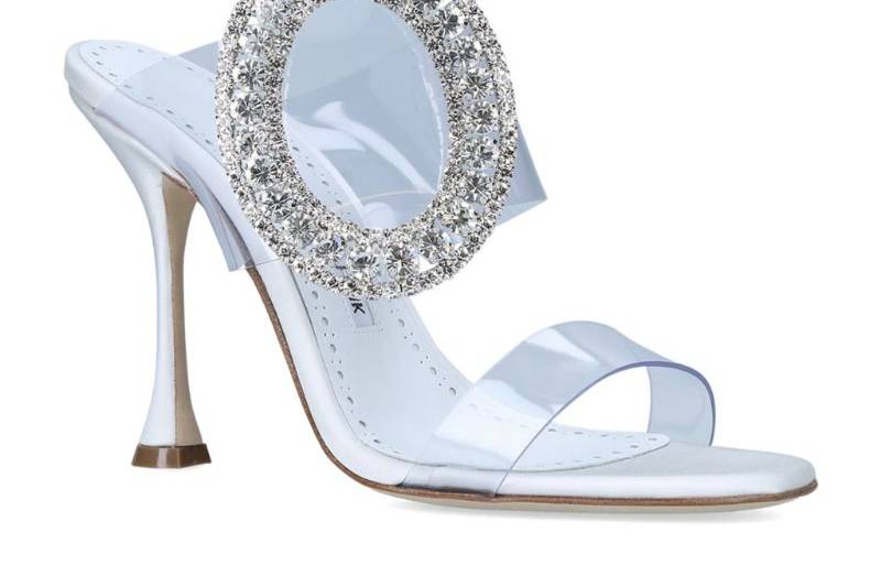 White heel with a large crystal embellishment on the ankle