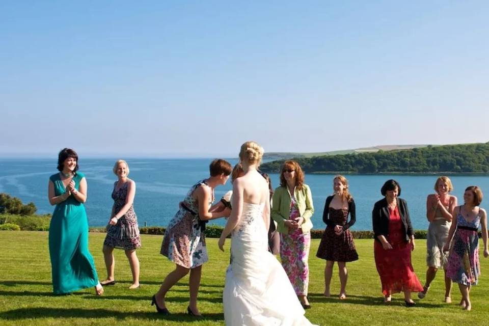 Bride with female guests on the lawn