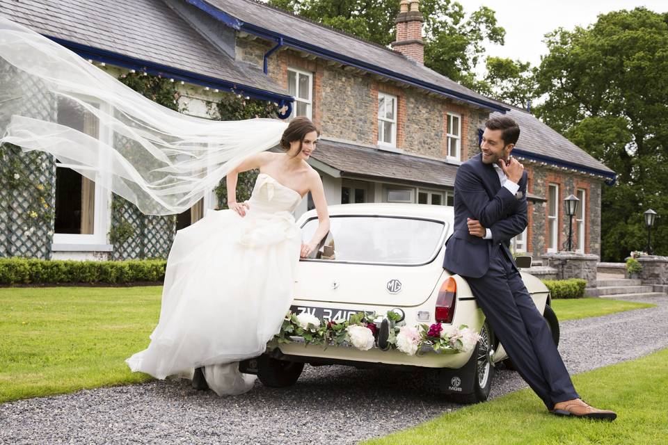 Our Couple with wedding car outside Virginia Park Lodge